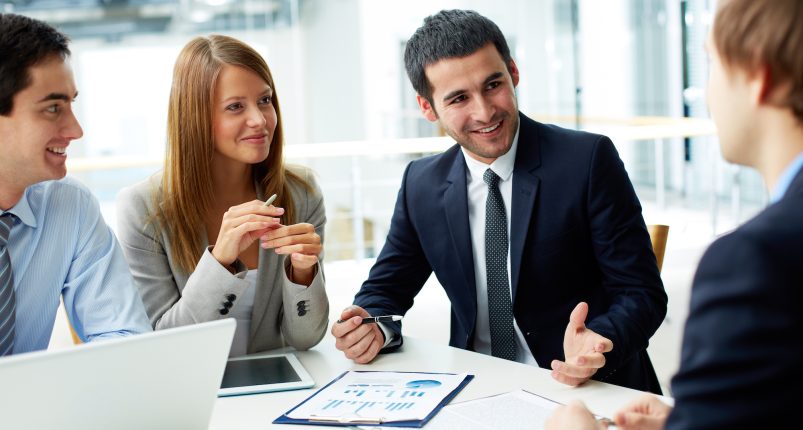 Image of business partners discussing documents and ideas at meeting